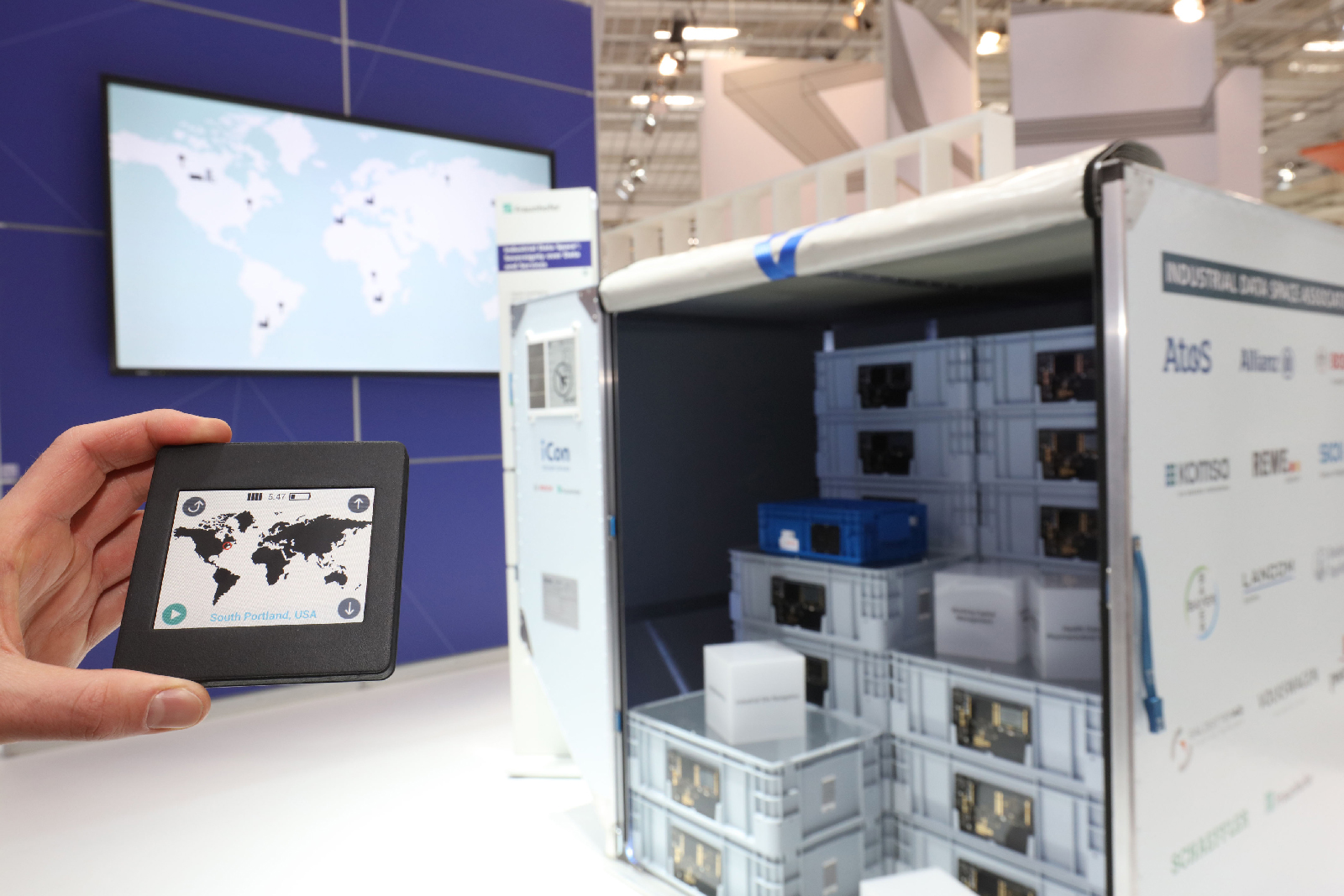 A mobile control unit (see foreground) can be used to communicate securely with a smart air freight container – just one of the applications for the Industrial Data Space.