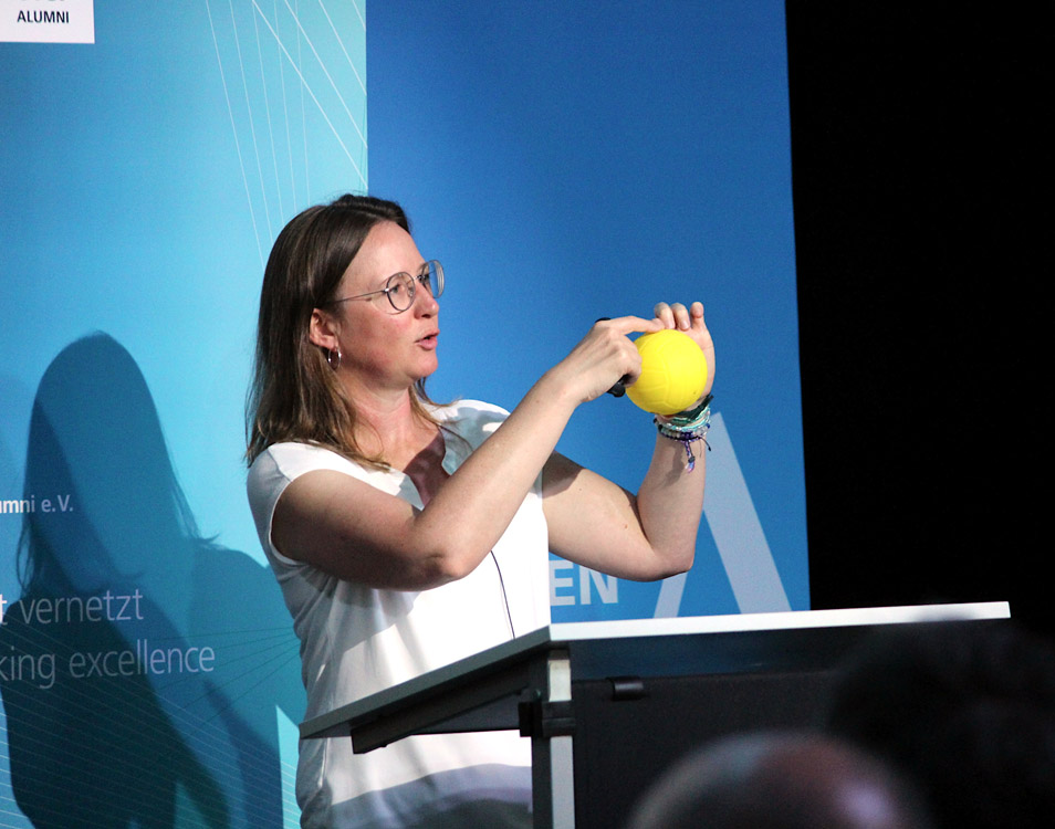 Dr. rer. nat. Hannah Venzl, Leiterin der Geschäftsstelle des Kompetenznetzwerkes Quantencomputing der Fraunhofer-Gesellschaft, illustriert anhand eines Balls das Konzept der Überlagerung von Zuständen, die ein Qbit haben kann. 