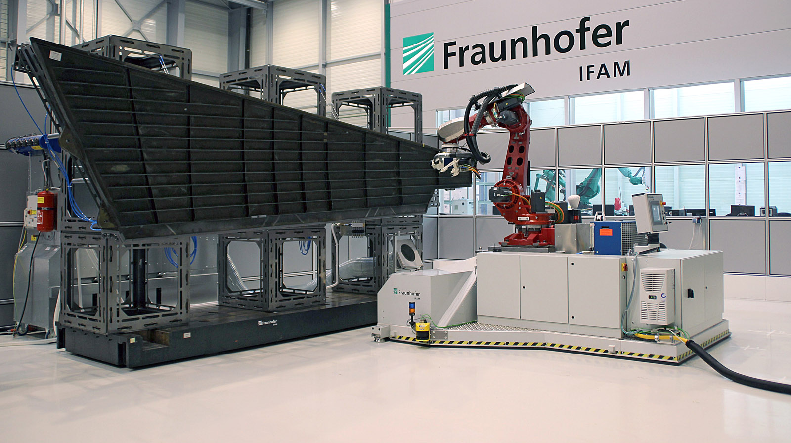 The mobile robot is processing the tail-fin of an Airbus 320 aircraft.