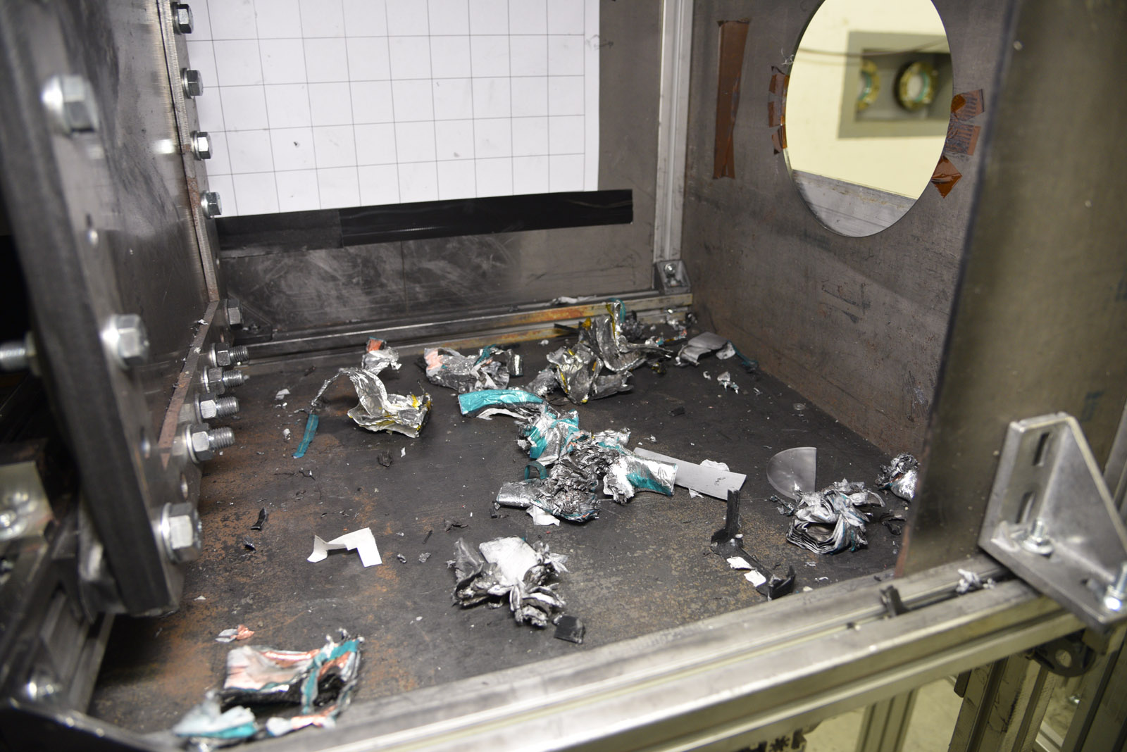 Fragments of a drone battery following impact with an aluminum plate on the test bench.