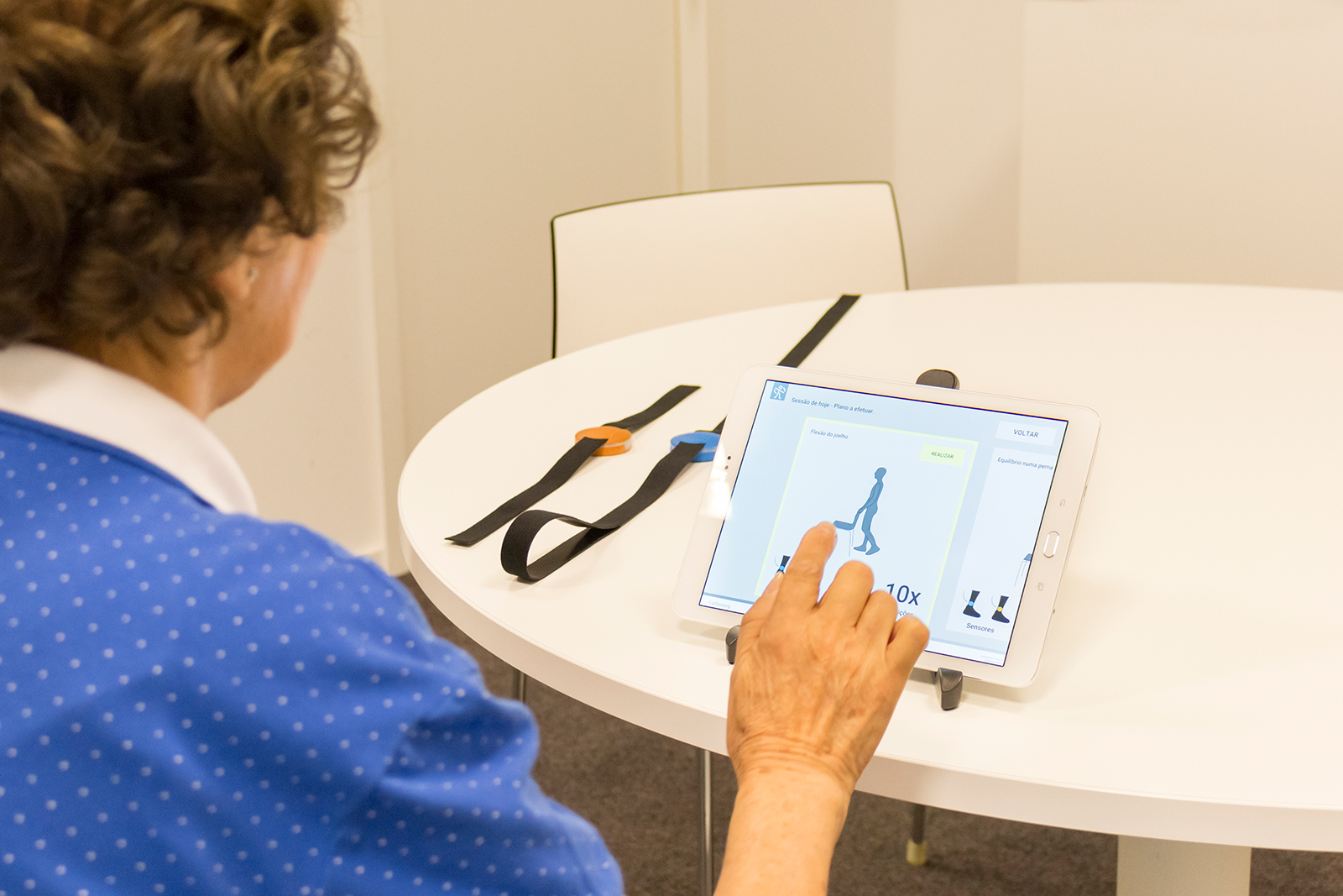 Frail people and those at risk of falling can also practice at home with the tablet app. On the left in the image: the sensors that register all of the movements.