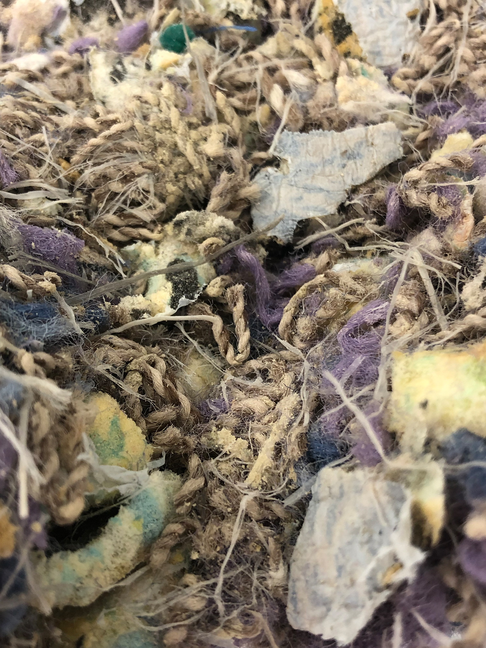 Broken-down carpet waste that is subsequently cleaned and has ionic liquid added to it.