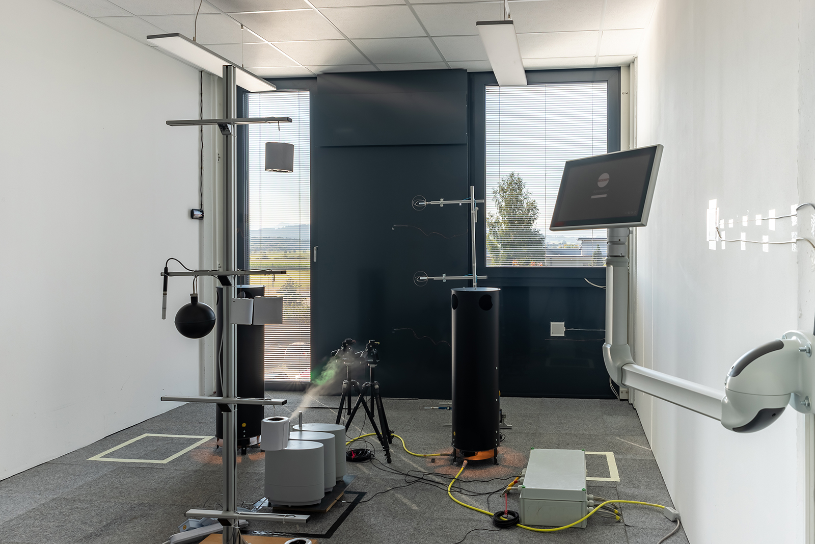 View of the test room behind the modular facade containing measuring instruments.