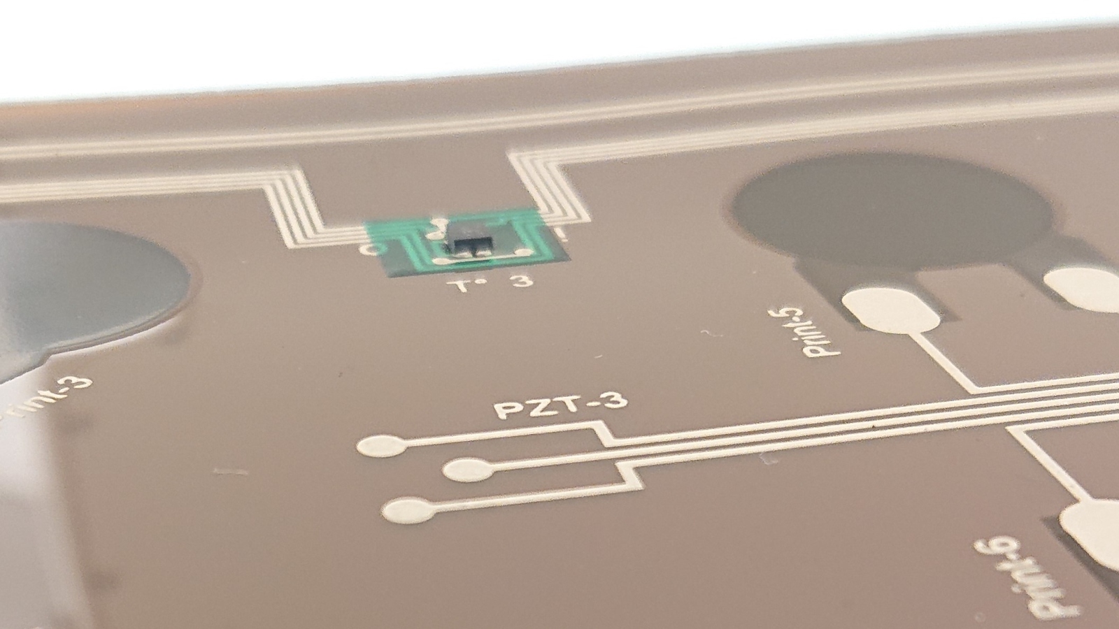 Details of the printed circuit board for the battery sensor system with mounted temperature sensor and printed ultrasonic sensors.